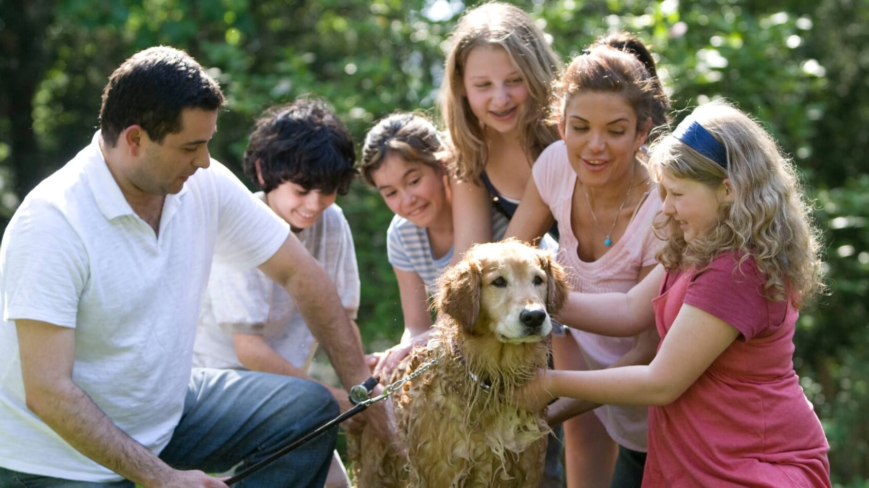Family washing dog with confidence in their Alliant Health Plans
