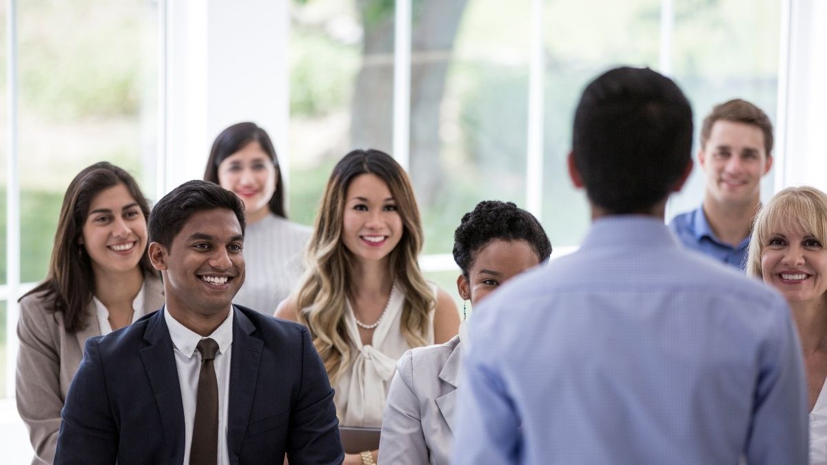 Team of professionals listening to a presentation on the top 10 employee benefits