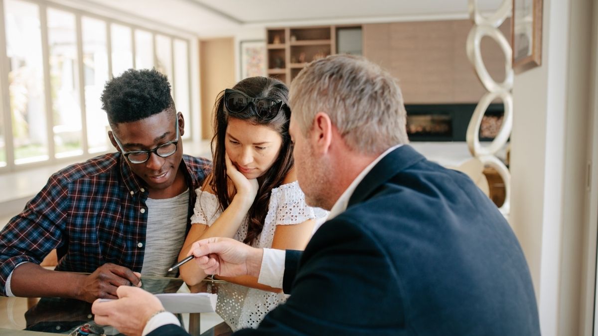 Couple reviewing health coverage options with an advisor, discussing COBRA Insurance choices and benefits.