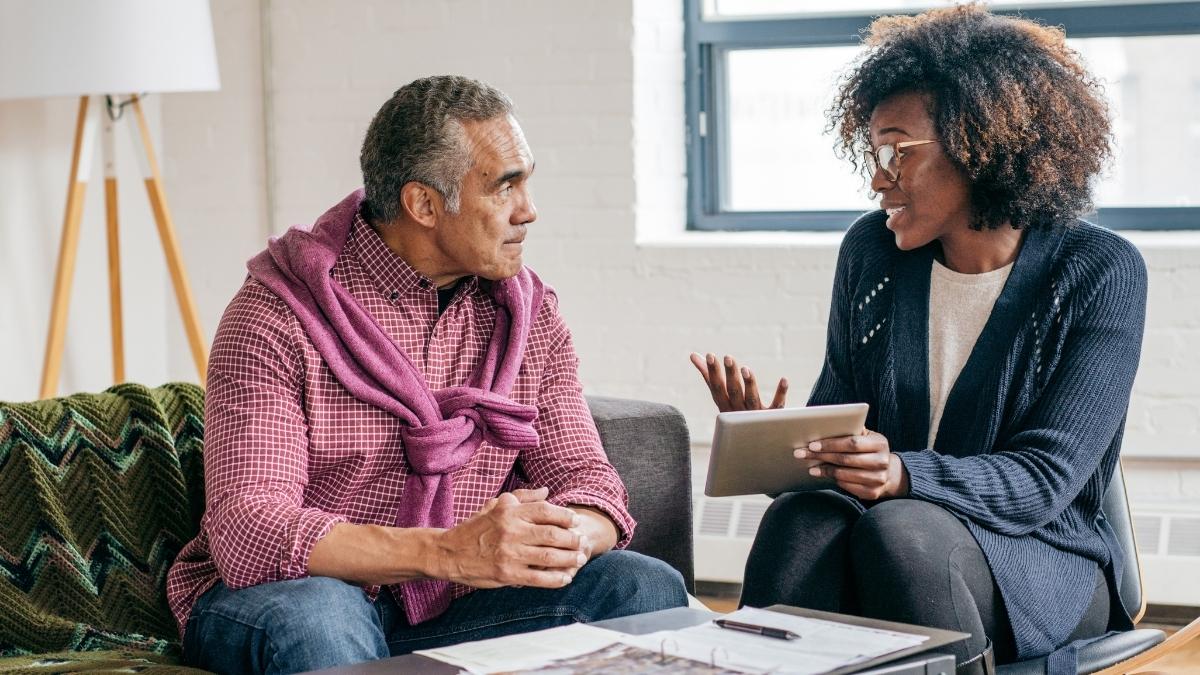 Insurance advisor discussing policy options with a client, illustrating the question is $200 a month a lot for health insurance.