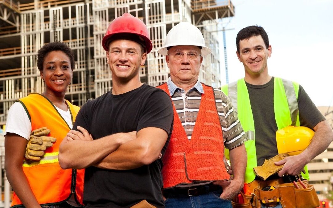 Construction workers on a job site wearing safety gear – blog image for health insurance for construction workers.