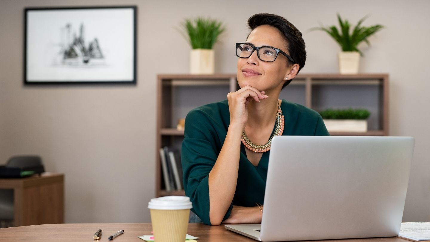 Woman thinking while researching if she can buy health insurance and use it immediately on her laptop.