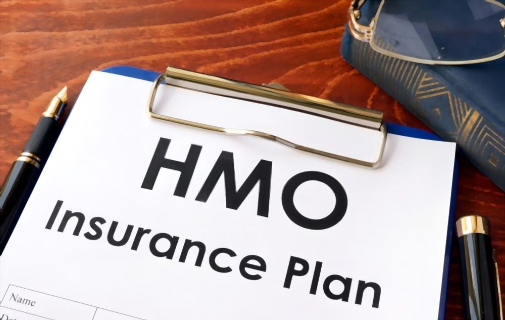 A clipboard with the text 'HMO Insurance Plan'