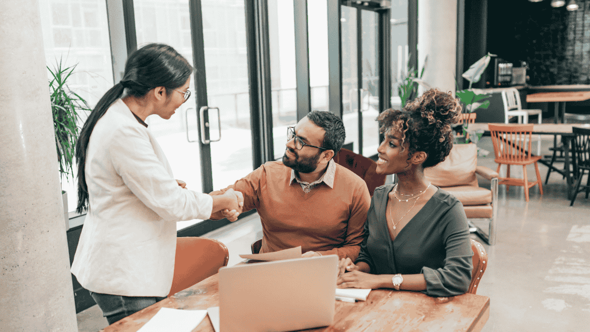 Two professionals in a serious discussion during a meeting about direct primary care health sharing options.